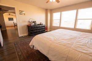 Bedroom with dark wood finished floors and ceiling fan