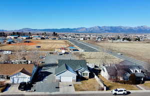Aerial perspective of suburban area featuring a mountain backdrop