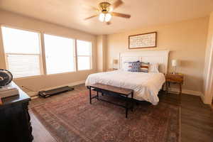 Bedroom featuring dark wood-style flooring and ceiling fan