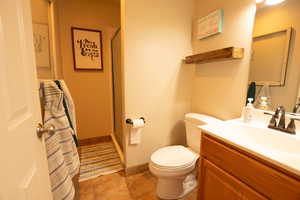 Bathroom with a stall shower, vanity, and light tile patterned floors