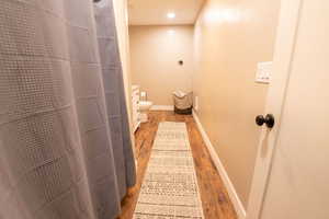 Full bathroom with a shower with curtain, recessed lighting, wood finished floors, and vanity