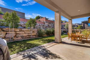 View of patio with area for grilling and outdoor dining space