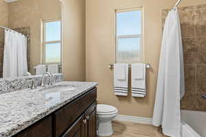 Full bath featuring vanity and shower / tub combo with curtain