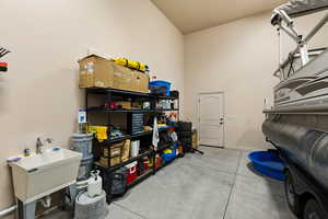 Garage with a sink and baseboards