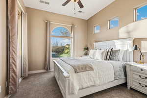 Bedroom featuring dark carpet and a ceiling fan