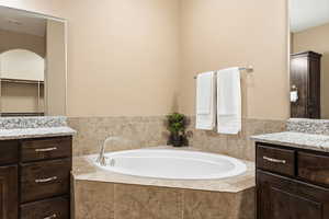 Bathroom with vanity and a garden tub