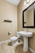 Half bath featuring baseboards and wood tiled floors