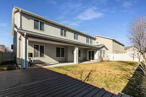 Rear view of house featuring a patio area and a fenced backyard