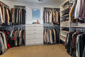 Walk in closet featuring light carpet