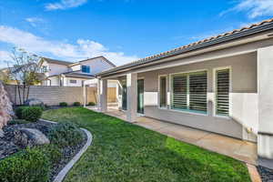 Fenced backyard with a patio area