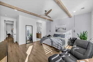 Bedroom with connected bathroom, recessed lighting, wood finished floors, beamed ceiling, and a ceiling fan