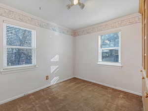 Unfurnished room with light carpet and baseboards