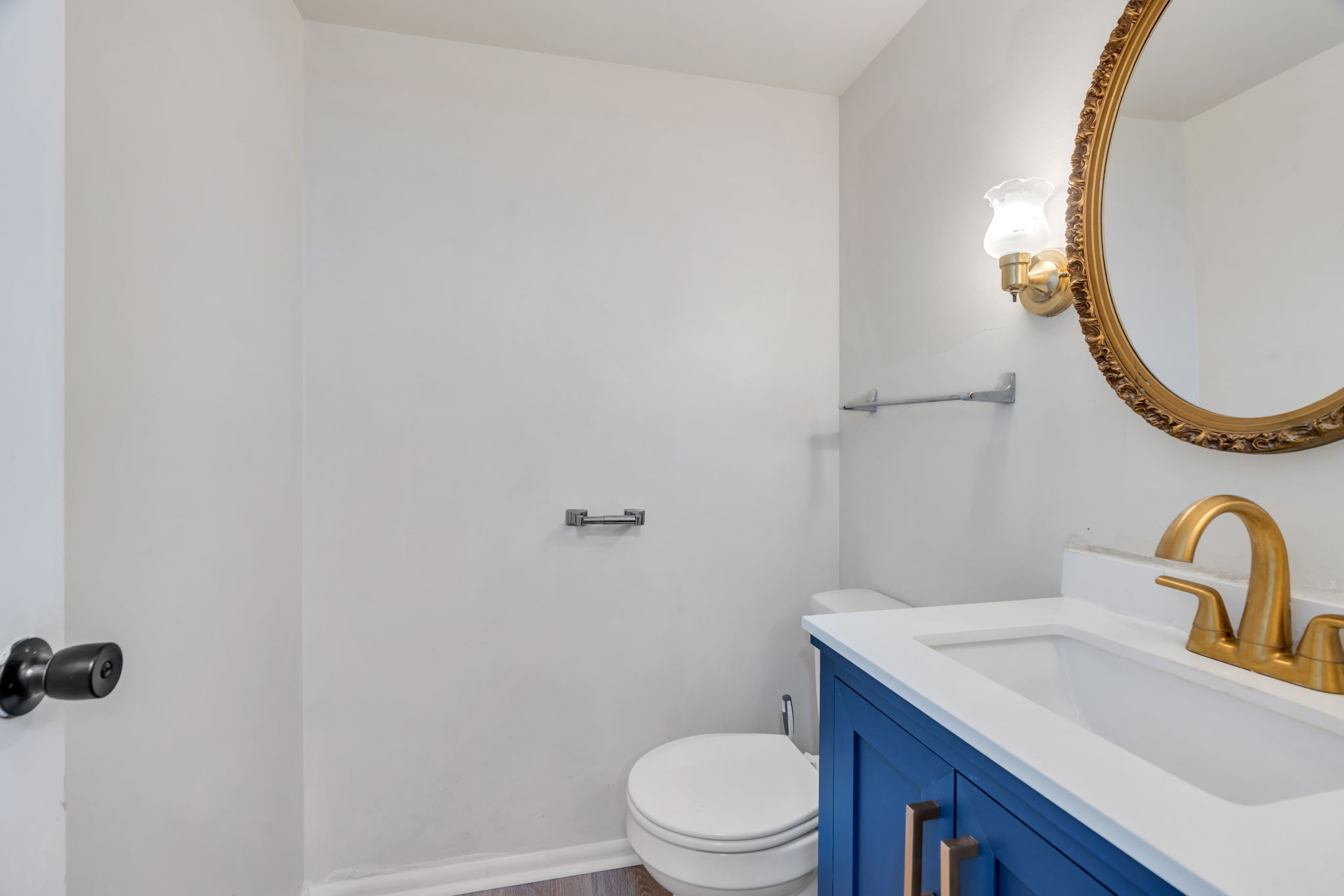 Half bath featuring vanity and toilet