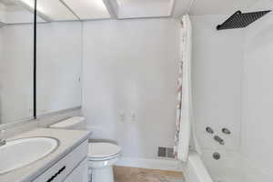 Bathroom featuring shower / tub combo with curtain and vanity