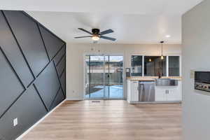 Kitchen/dining area with light wood finished floors, ceiling fan, and recessed lighting