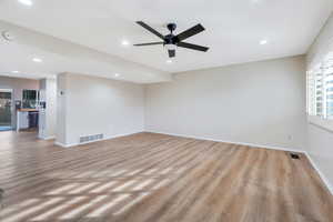 Living room featuring light wood-style floors, recessed lighting, and ceiling fan