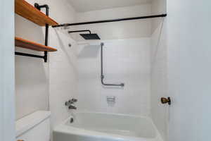 Full bath featuring shower / washtub combination and toilet