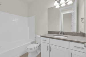 Full bathroom with vanity and washtub / shower combination