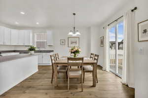 Dining space featuring light wood-type flooring, recessed lighting, and a chandelier