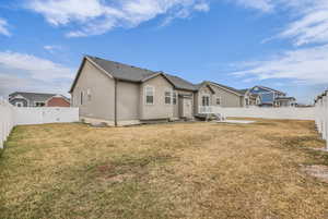 Back of property featuring a fenced backyard, a gate, and stucco siding