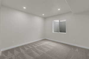 Unfurnished room with light colored carpet and recessed lighting