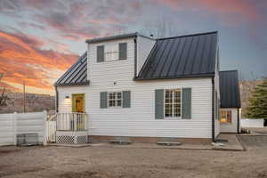 Back of property with a metal roof