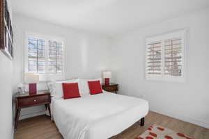 Bedroom with light wood-style floors and baseboards