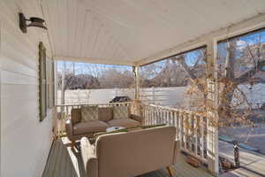Snow covered deck featuring an outdoor living space