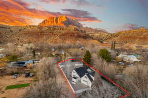 Aerial view at dusk of property boundaries highlighted and a mountain view