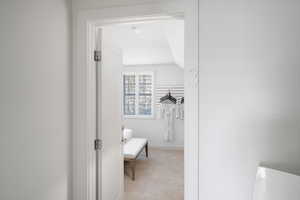 Bathroom featuring lofted ceiling and baseboards