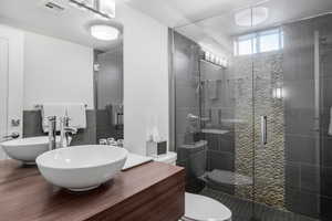 Full bath with vanity and a shower stall