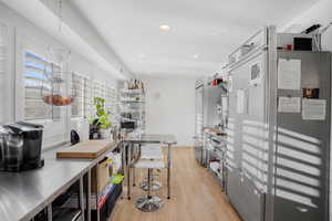 Kitchen featuring decorative light fixtures, light wood-type flooring, and recessed lighting