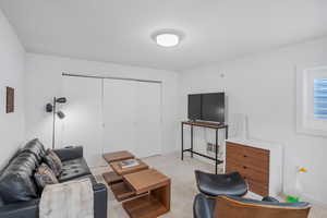 Living room featuring light colored carpet