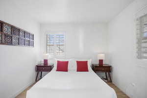 Bedroom featuring light wood-type flooring and baseboards