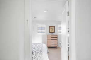 Bedroom featuring light carpet
