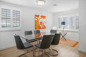 Dining room with light wood finished floors and baseboards