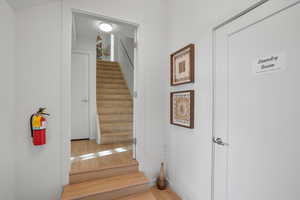 Stairway featuring wood finished floors and baseboards