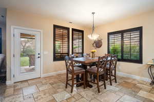 Dining area featuring stone tile flooring