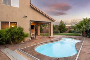 View of swimming pool with a patio area and a fenced backyard