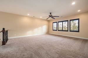 Spare room featuring light carpet, recessed lighting, and ceiling fan