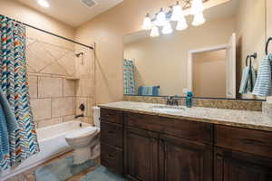 Full bath featuring shower / tub combo and vanity