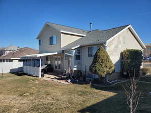 Back of house with a fenced backyard, a shingled roof, a patio, and french doors