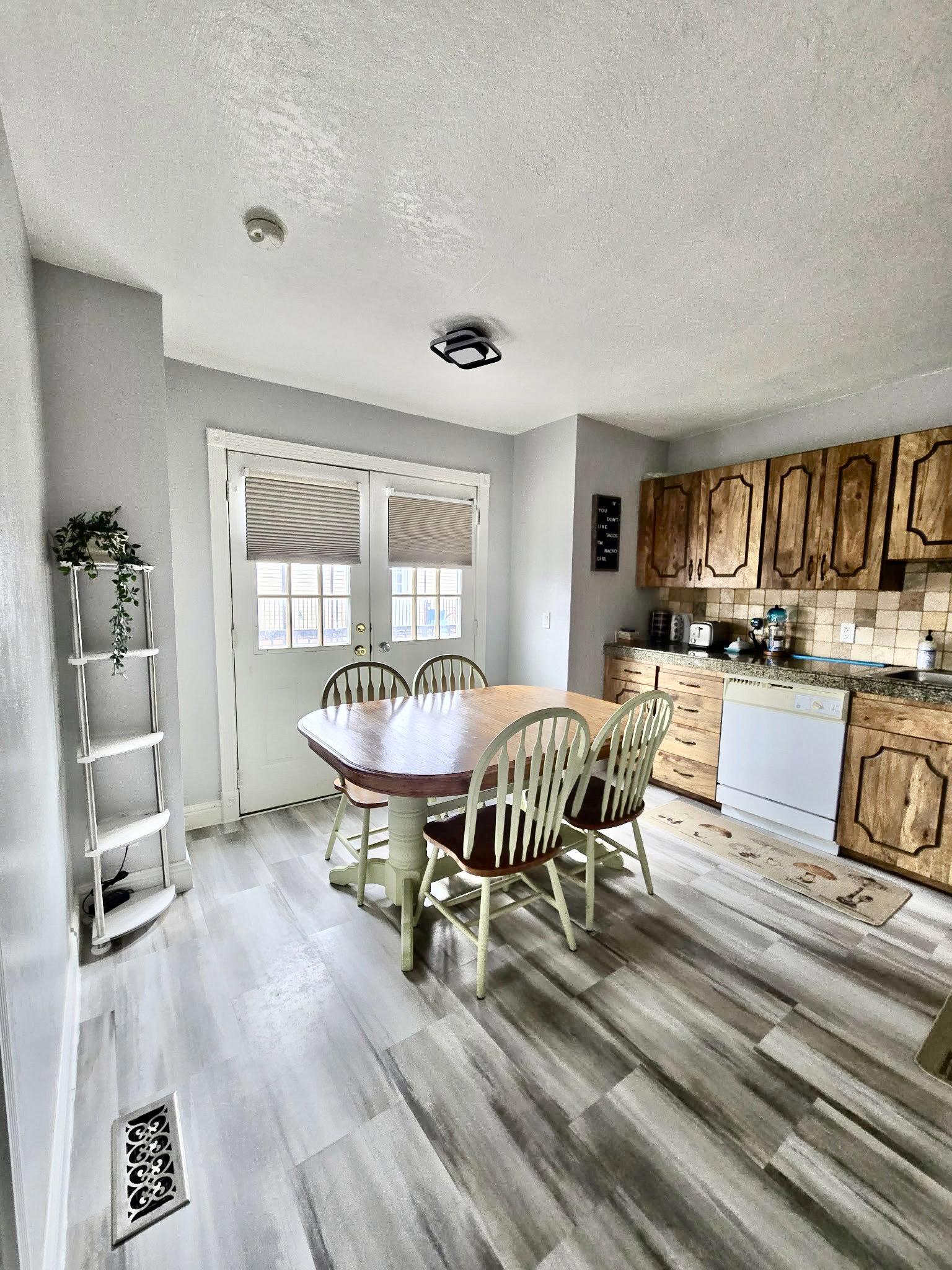Dining space with a textured ceiling and baseboards
