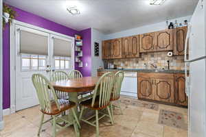 Dining room featuring light tile patterned flooring and a textured ceiling
