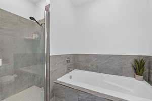 Full bathroom with a stall shower and a bath