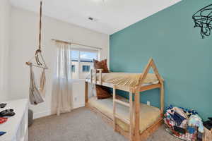 Bedroom featuring light colored carpet and baseboards