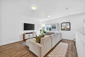 Living area with light wood finished floors and stairs