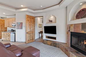 Living area with a tile fireplace, recessed lighting, and light tile patterned floors