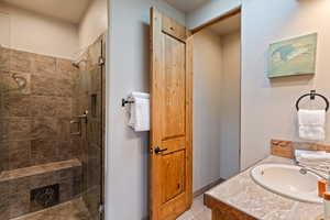 Bathroom with vanity, a stall shower, and light tile patterned flooring