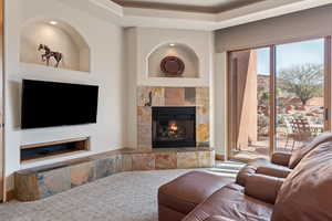 Living area featuring a fireplace and carpet flooring